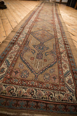 Repeating geometric medallions down the length of an antique camel hair Serab Persian runner.