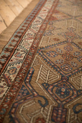 Low pile and intricate pawn and serrated leaf borders of a camel hair antique Serab runner.