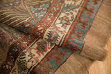 Rolled edge of an antique Camel Hair Serab runner showing the soft pile and detailed pawn border.