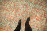 Textured distressed Mahal rug featuring muted brick red, dusty teal, and ivory floral designs.