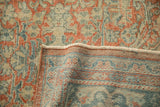 Distressed pale brick red and teal Mahal rug pile with visible hand-knotted foundation.