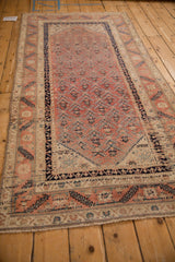 Antique Malayer rug runner viewed at an angle, highlighting its dynamic color variations and serrated leaf design.