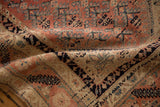 Low pile and textured weave of an antique Malayer rug with geometric motifs in blush, navy, and beige.
