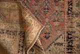 Corner of an antique Malayer runner showing its hand-knotted back and low-profile pile.