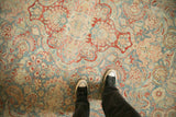 Distressed vintage Kashan rug with faded sky blue, pomegranate floral and leafy design.