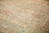 Faded red and sky blue floral boteh on distressed vintage Kashan carpet.