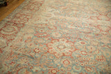 Distressed vintage Kashan carpet, featuring softened sky blue and pomegranate red floral designs.
