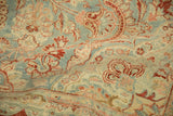 Worn Kashan rug detail; sky blue, pomegranate, and blush scrolled floral motifs.