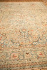 Perspective view across the soft, low pile of a distressed Tabriz, focusing on the pawn and vine borders.