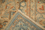 Hand-knotted foundation and secured edge visible on a folded corner of the vintage Tabriz carpet.