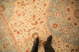 The sharp serrated lightning arabesque spandrel and distressed pile of a vintage Tabriz carpet.