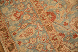 Textured wear across knot heads on floral and geometric motifs of a distressed Tabriz carpet.