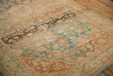Heavy color abrashes and low, even wear on a vintage Persian rug in teal, charcoal, and terra cotta.
