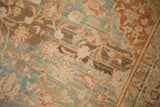 Worn, hand-knotted texture of a distressed Mahal rug with heavy teal and brown color abrash.