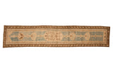 Vintage distressed Caucasian runner with lozenge medallions in dusty sky blue, ivory, and coffee brown.
