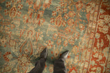 Close-up of the short pile on a distressed antique Sarouk carpet showing its texture and floral pattern.