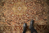 Overhead view of a distressed Bakhtiari rug's low pile and scrolled floral medallion patterns.