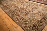 Vintage Bakhtiari runner seen from an angle, showing the texture of its low pile and intricate borders.