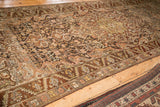 Angled view of a distressed Bakhtiari runner's serrated leaf and geometric floral borders.