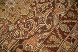Scrolled arabesques and geometric blossoms showing the even, low-pile texture of a vintage Persian rug.
