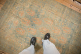 A view from above showing the soft, time-worn texture of a vintage Persian rug in powder blue and apricot.