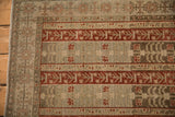 Intact side cord selvage and even pile of a distressed Bijar rug with red agricultural panels.
