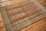 Angled view of a distressed Bijar rug's unidirectional panels in red and coffee brown hues.