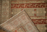 A folded corner reveals the hand-knotted foundation of this distressed vintage Bijar rug.