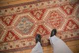 A personal perspective showing the scale of the distressed Serab runner's geometric pattern.