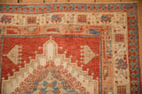 Geometric pawn motif border in red and sky blue on a distressed vintage Serab runner with even wear.