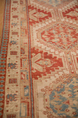 Angled view showing the pawn design border and distressed, low-pile texture of the Serab runner.