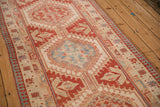 Angled view of a vintage Persian Serab runner highlighting the interconnected geometric medallions.