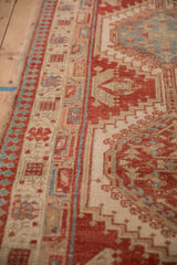 Close view of the reciprocating pawn motif on the distressed Serab rug border.