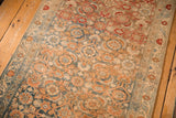 Time-softened Herati pattern of a distressed Malayer runner in terra cotta, blue, and sandalwood tones.