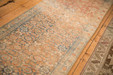 Angled view of a distressed Malayer runner highlighting its evenly worn pile and Herati motif.