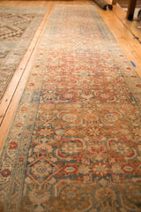 Long perspective view of the vintage Malayer runner's distressed, allover Herati motif.