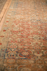Close-up angle on the worn, low-pile texture of a vintage Malayer runner with Herati motifs.