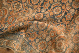 A soft fold in the vintage Malayer rug reveals its even wear and low pile texture.