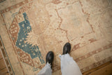Distressed low pile texture of a vintage Hamadan rug showing dusty blue and coffee brown geometric motifs.