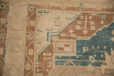 Close-up of the pinwheel floral and vine motifs within the hand-knotted border of the rug.