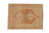 Distressed vintage Afshar rug with a copper double medallion, geometric boteh field, and dusty blue accents.
