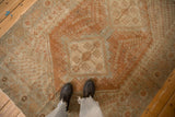 The low-pile texture and time-softened copper and blue tones of a vintage Afshar rug seen from above.