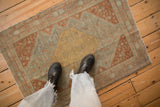 A distressed Northwest Persian rug in powder blue and rust, styled to show its scale.
