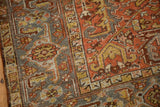 Detail of the turtle samovar and serpent borders on a distressed Mehrivan rug with worn texture.