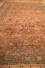 Angled view of a vintage Heriz rug, highlighting its sprawling geometric pattern and low, even pile.