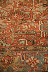 Close-up on the mostly even wear and hand-knotted texture of a vintage Heriz carpet.