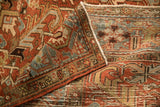 A folded corner of the vintage Heriz carpet showing its hand-knotted texture and even wear.