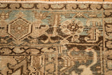 Close-up of the distressed Heriz rug's turtle samovar border, showing a low, worn pile.