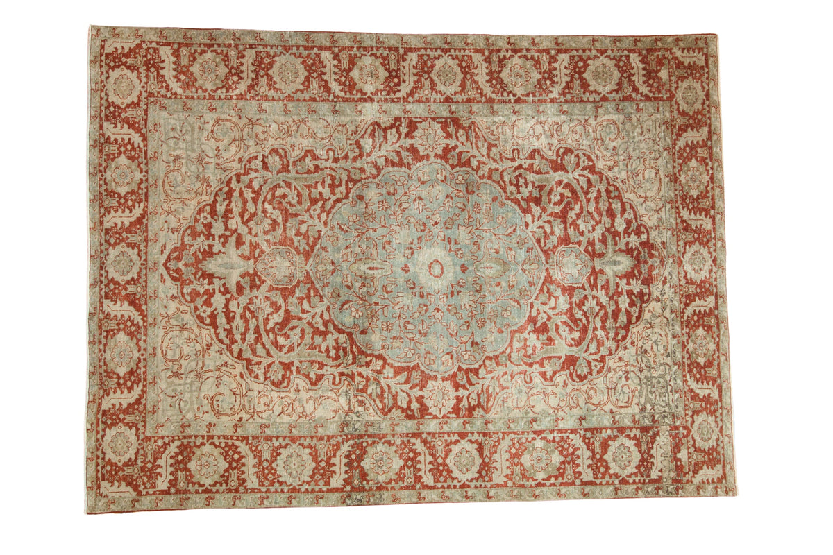Vintage distressed Ahar carpet with a scalloped medallion and sprawling vines in pomegranate red and dusty blue.