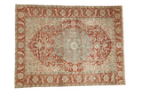 Vintage distressed Ahar carpet with a scalloped medallion and sprawling vines in pomegranate red and dusty blue.